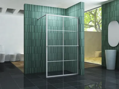 A modern bathroom with green tiled walls and a glass shower enclosure.