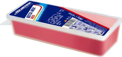 A rectangular container of red ski wax.