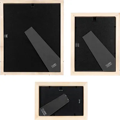 Backs of three wooden picture frames of different sizes, showing the stand and backing.