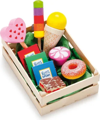 A wooden crate filled with toy sweets.