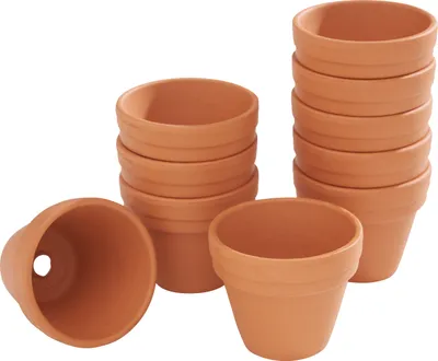 Several terracotta pots are stacked and arranged on a white background.