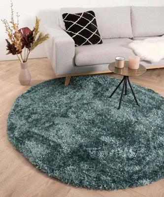 Imagen del producto de Alfombra redonda Unyqoos® de terciopelo de pelo alto, color turquesa, diámetro 80 cm. Fabricada en poliéster, con una altura de pelo de 50 mm y un brillo suave