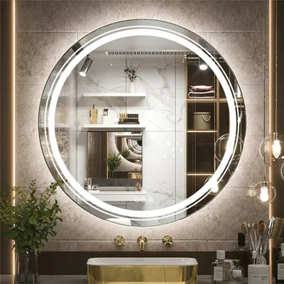 A modern bathroom vanity with a round LED mirror, sink, and faucets.