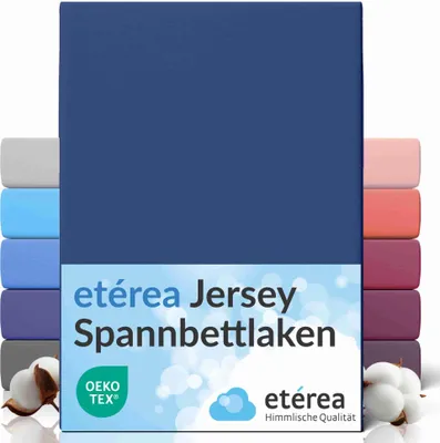 A stack of folded jersey fitted sheets in various colors, with a navy blue sheet prominently displayed in the front.