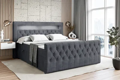 A dark gray upholstered bed with a tufted headboard and footboard, featuring built-in LED lighting, is shown in a bedroom setting.