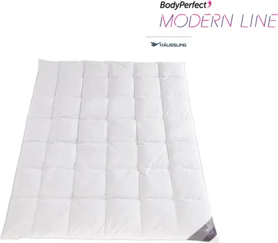 A white duvet with a quilted pattern is laid out flat, with branding and text in the upper right corner.