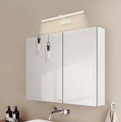 A modern bathroom vanity with a mirrored cabinet and integrated lighting.