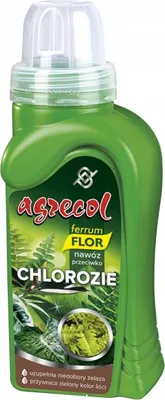 A green bottle of liquid fertilizer with a label.