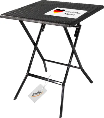 A black folding table with a rattan-like texture on the tabletop.