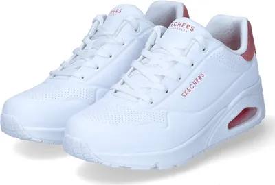 A pair of white Skechers sneakers with pink accents.