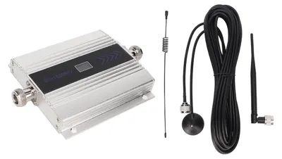 A cell phone signal extender amplifier and its accessories are laid out on a light gray background.