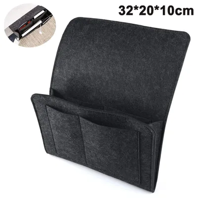 A dark gray felt bed organizer with multiple pockets, shown from a slightly elevated diagonal angle.