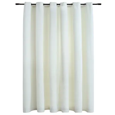 A cream-colored curtain hanging from a dark rod.