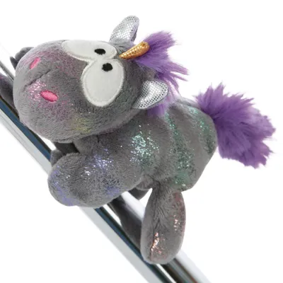 A plush unicorn toy is shown on a reflective surface.