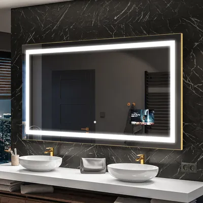 A modern bathroom with a large illuminated mirror over a countertop with two sinks.