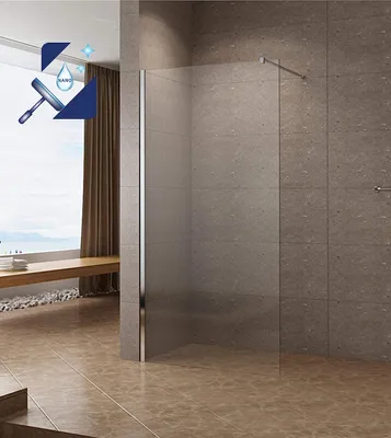 A modern bathroom with a glass shower enclosure and tiled walls.