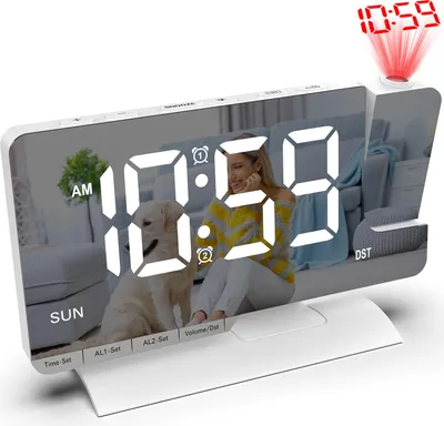 A digital alarm clock with a projected time display, showing a woman and a dog reflected on its screen.