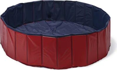 A round, collapsible dog pool with red outer walls and a blue inner lining.