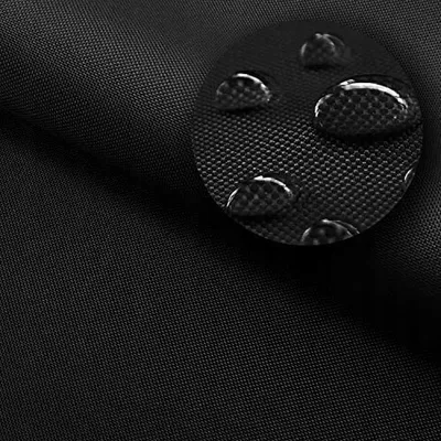A close-up view of black fabric with water droplets on it, highlighting its waterproof properties.