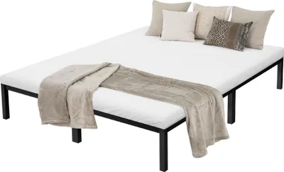 A bed frame with a mattress, pillows, and a blanket.