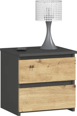 A nightstand with two drawers and a lamp on top.