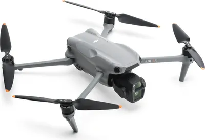 A gray drone with black propellers is shown against a white background.