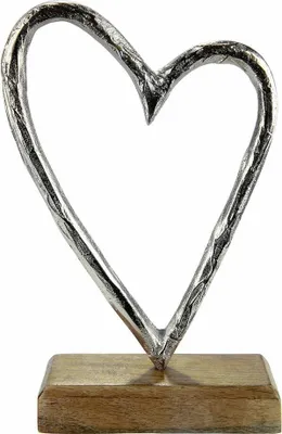 A silver heart sculpture on a wooden base.
