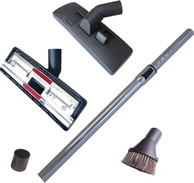 A collection of vacuum cleaner attachments and parts arranged on a white background.