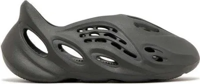 A single, dark gray Yeezy Foam Runner shoe is shown from a side-angle on a white background.