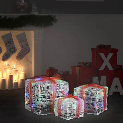 Christmas decorations in a living room setting with a fireplace and stockings.