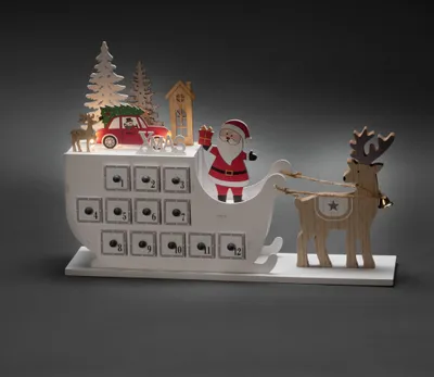 Produktbild von Konstsmide LED Holzsilhouette, "Adventskalender mit Schlitten", 6h Timer, 3 warm weiße Dioden, batteriebetrieben, Innen, transparentes Kabel, Batterie: 2 x AAA 1,5V (exkl.) - 3263-210