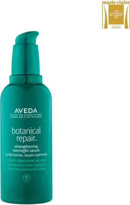 A product shot of an Aveda Botanical Repair Strengthening Overnight Serum bottle with a Marie Claire award badge in the top right corner.