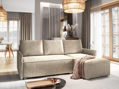 A modern living room with a beige sectional sofa and ottoman.