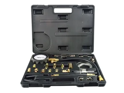 A black plastic case containing a compression tester kit for gasoline engines.