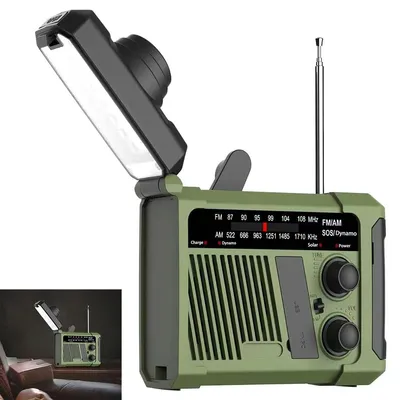 A green emergency radio with its LED light flipped open, displayed against a white background. A smaller inset image shows the radio in a dimly lit room.