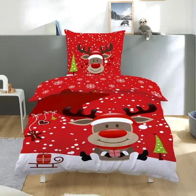 A Christmas-themed duvet cover set with a reindeer design is displayed on a bed.