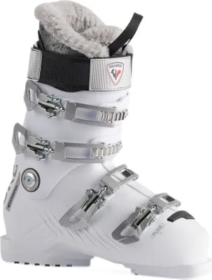 A white ski boot with silver buckles and gray fur lining.