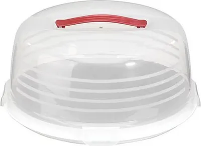 A clear plastic cake carrier with a red handle.