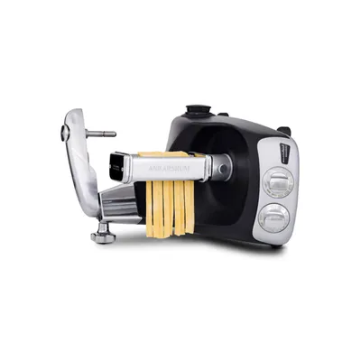 A pasta roller attachment for a kitchen appliance, with fresh pasta noodles coming out of it.