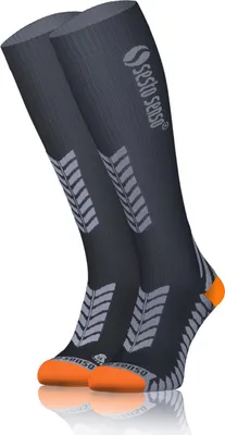 A pair of dark gray compression socks with orange toes and heels, and a gray chevron pattern on the calf.