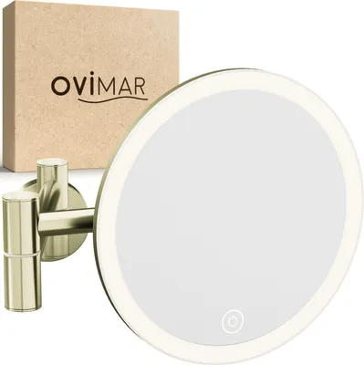 A gold-colored cosmetic mirror with LED lighting is shown mounted on a wall, with its packaging in the background.