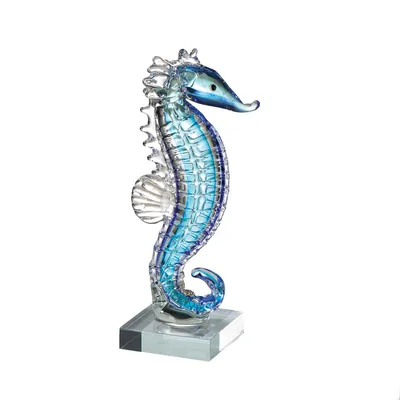 A glass sculpture of a seahorse on a clear base against a white background.
