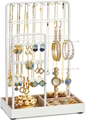 A white jewelry stand filled with various necklaces, earrings, bracelets, and a watch.
