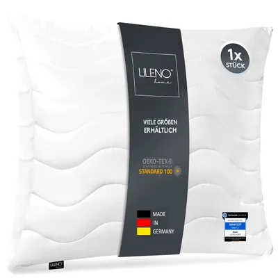 A white pillow with a dark grey band wrapped around it, displaying product information.