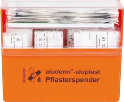 An orange first aid dispenser filled with various bandages.