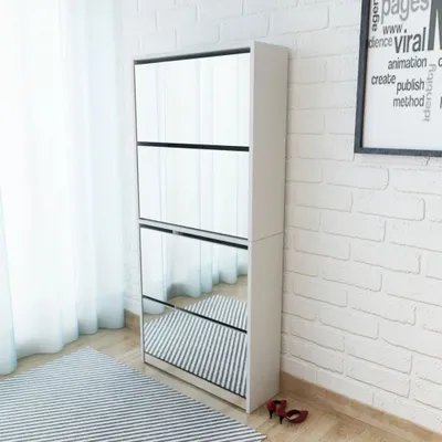A tall, white shoe cabinet with mirrored doors stands in a room with white brick walls and a striped rug.
