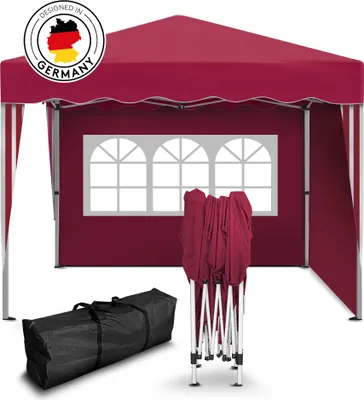 A red pop-up gazebo is shown, with a folded frame and a carrying bag in the foreground. A 'Designed in Germany' logo is visible.