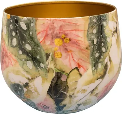 A close-up view of a decorative pot with a floral and leaf pattern.