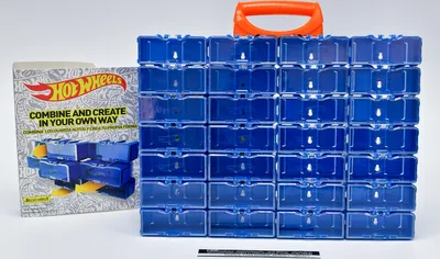 A Hot Wheels storage case filled with compartments and a box of Hot Wheels.