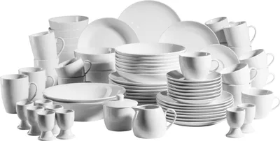 A collection of white porcelain dinnerware, including plates, bowls, cups, and egg cups, arranged on a white background.